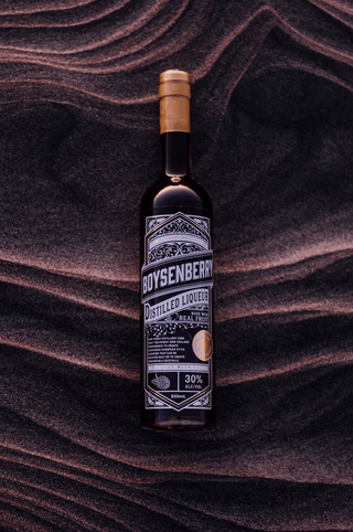 Boysenberry Liqueur on a black sand beach as the sun goes down