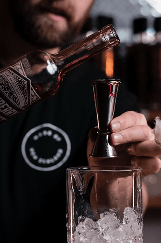 Jeremy pouring a shot of Boysenberry Liqueur 