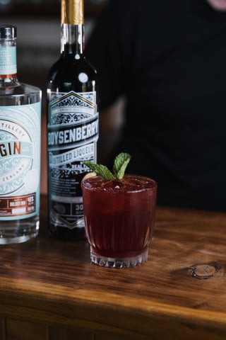 Boysenberry Buck with Delightful Gin and Liqueur Bottles
