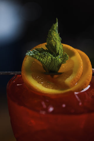 Boysenberry Gin Fizz cose up of garnish of orange and mint