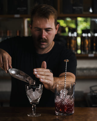 Boysenberry Gin Fizz Jeremy chills the glass with ice