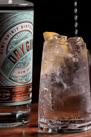 Delightful Dry Gin label close up with a ice filled Gin and Tonic