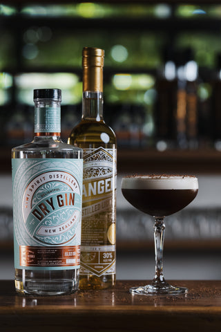 Delightful Gin and Tangelo Liqueur on a wooden bar with an espresso martini cocktail