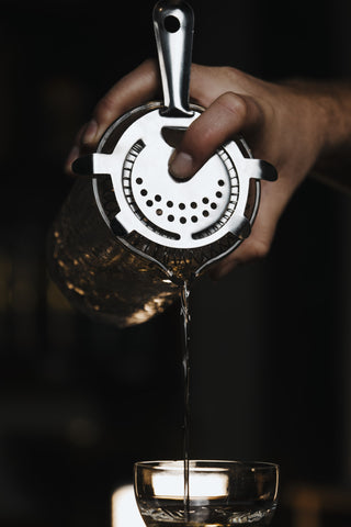 Gimlet poured through strainer into glass