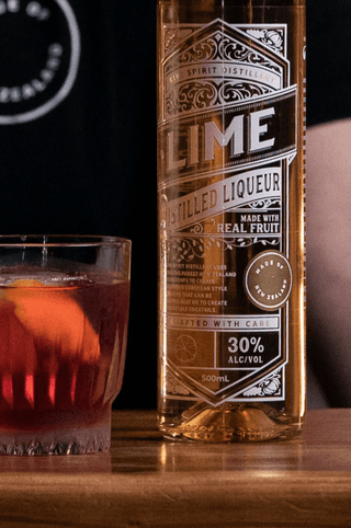 Lime Liqueur label close up with a negroni cocktail