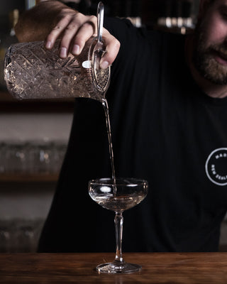 Millionaires Martini Delightful Gin mix poured form a height