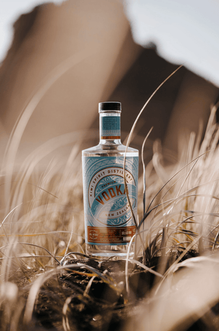 Premium New Zealand Vodka fade out picture at the beach in the grass