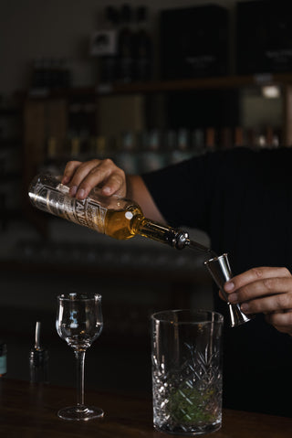 Tangelo Smash Tangelo Liqueur poured from glass into jigger