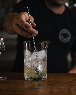 Stirring in the mixing glass to melt some ice