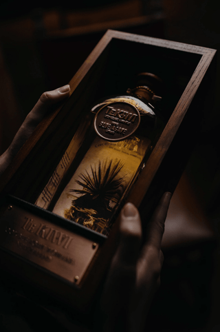TeKiwi 100% Blue Agave Bottle and Box  held in hands