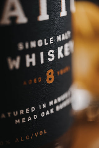 Ultra close up of the gold 8 year badge on the Waitui Whiskey label