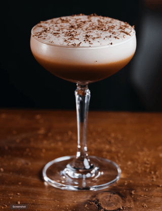 Stunning espresso martini served in a martini glass with a ombre foam. Chocolate grated across the top