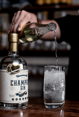 Championz Gin is pictured along side the classic gin and tonic, bubbly tonic is poured from a height into the tall glass