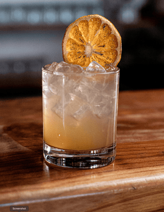 A large bold dried orange round garnishes this cocktail of vodka and Wild Manuka Tonic