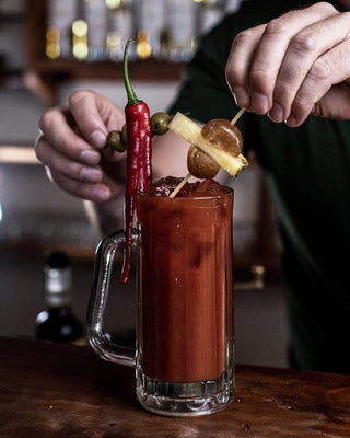 Building garnish on a bloody mary cocktail