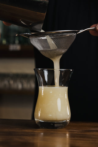 Pouring cocktail into glass