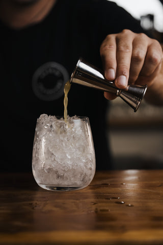 Bramble cocktail poured into glass