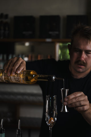 Tangelo Liqueur poured into wine glass