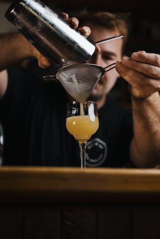 Delightful Ginger pouring from shaker into glass