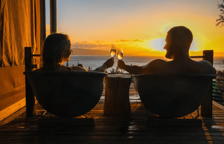 Cheers at sunset in the outside bath