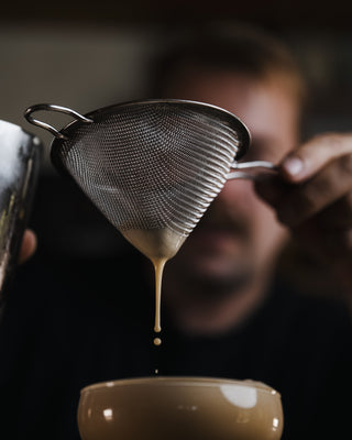 Pouring the Espresso Martini into martini glass