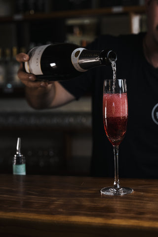 Boysenberry liqueur and sparkling wine poured into champange glass