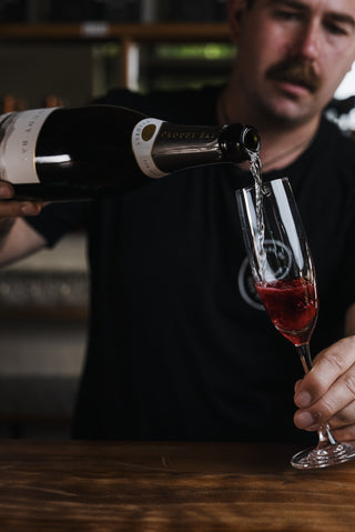 Jeremy pouring Kir Royal at the bar