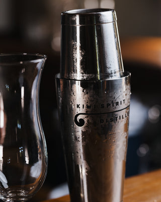 Cold cocktail shaker on wooden bar