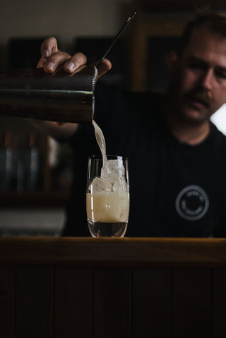 Pohara Sunrise Pouring into glass on bar by Jeremy