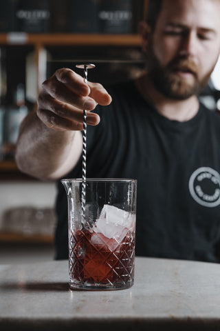 Stirring the spring punch in mixing glass