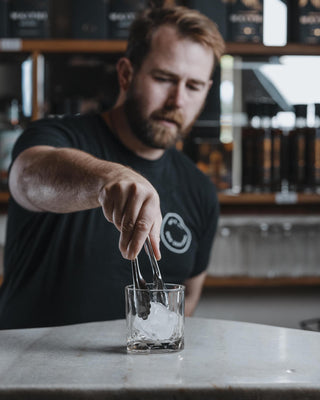 Large ice cube into rocks glass