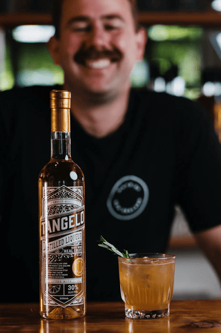 Jeremy smiling behind the Tangelo Liqueur and Vegan Lamb Shank cocktail
