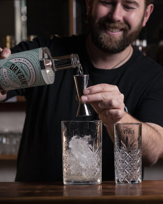 Pouring the Delightful Gin into mixing glass