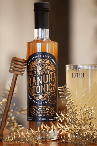 Wild Manuka Tonic with a prepared drink of wild manuka tonic on a wooden bar
